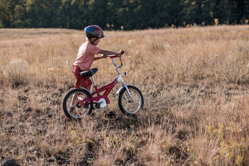 Small adorable biker portrait in rural scenery