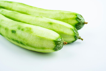 Fresh peeled loofah on white background