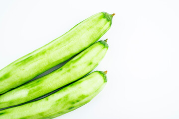 Fresh peeled loofah on white background