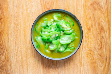 A dish of vegetable fried loofah on the table