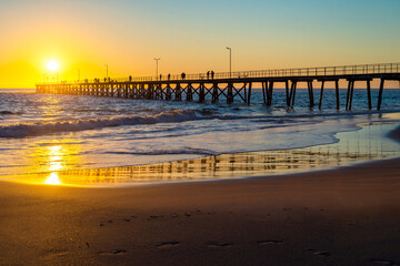 Fototapeta premium Fishermen on Port Noarlunga jetty at sunset, South Australia