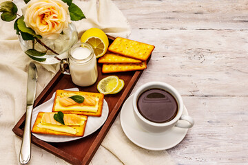 Healthy breakfast. Cup of coffee (black tea), milk, crackers with butter and salmon