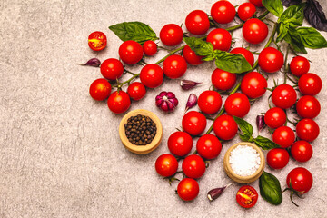 Naklejka na ściany i meble Ripe cherry tomatoes, garlic, basil, salt and black peppercorns on a stone culinary background