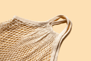 Obraz premium Natural mesh bag on a light background. Zero waste. Place for text. Flat lay.