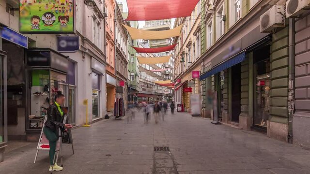 Walk on Ferhadija pedestrian street crowded with people timelapse hyperlapse. Famous place in downtown with many shops and reastaurants in Sarajevo