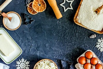 Ingredients for making Christmas cookies. Cottage cheese, flour, sugar, eggs, butter on a blue background,flat lay, top view, copy space. Christmas food background