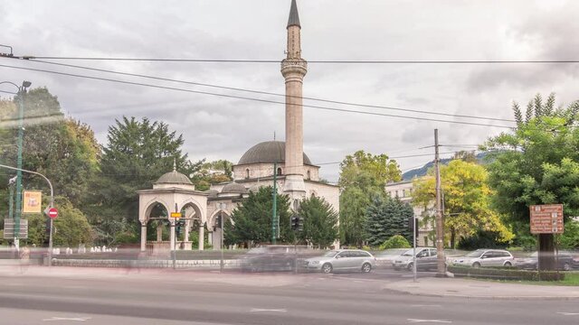 Ali Pasha Mosque timelapse hyperlapse with traffic on intersection, It was completed in 1561 after plans of Hadim Ali Pasha, Sarajevo, Bosnia and Herzegovina.