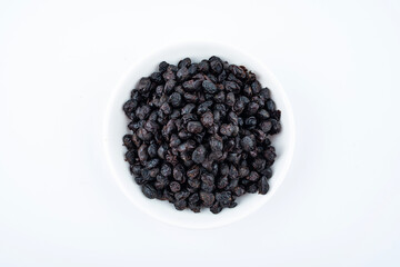 A saucer of black tempeh on white background