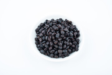A saucer of black tempeh on white background