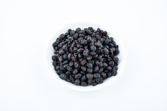 A saucer of black tempeh on white background