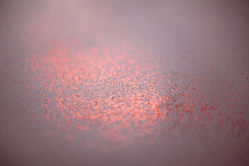 Coral abstract background with small bokeh defocused lights.