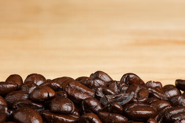 Coffee beans on wood background.