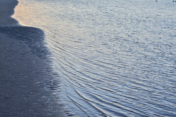 Sea waves at the seashore on a cloudy day.
