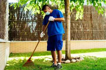 maintenance staff cleaning garden leaves