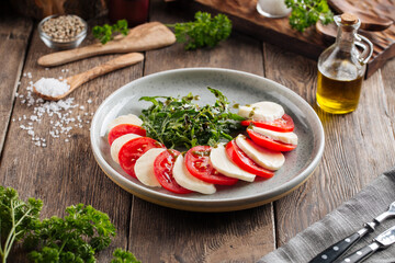 Classic italian caprese salad on the wooden table