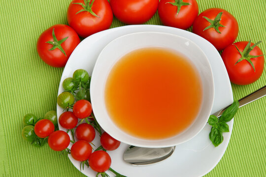 Tomato consomme with fresh tomatoes, flat lay