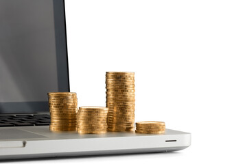 Stack of coins on laptop white background