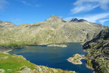 Fototapeta na wymiar Mountain lake called Embalse Bachimana in Pyrenees on a hiking trail GR11/HRP in Spain
