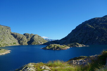 Naklejka premium Mountain lake called Embalse Bachimana in Pyrenees on a hiking trail GR11/HRP in Spain
