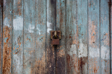 The texture of old door, which the old paint flaking.