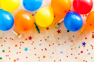 Flat lay with ballons - party concept - on beige background top-down copy space