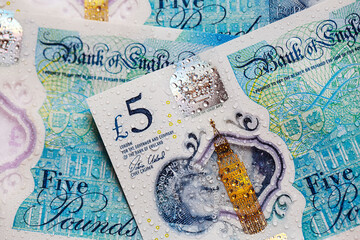  British currency - close up of the new 2016 polymer five pound note with enhanced counterfeit...