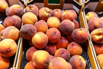 shopping fruits peach in supermarket. background, sale of ripe fruit