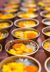 Buddhist flower offerings or gifts in bowls and rows