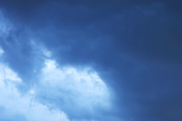 Naklejka na ściany i meble Dark blue stormy cloudy sky. Natural photo background