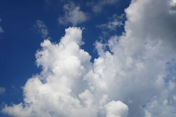 Deep blue skies with white clouds background with space for text, blue cloudy skies texture, blue sky wallpaper with white fully clouds and sunlight