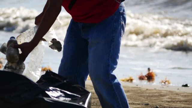 Activity of Indonesian valunteer group keeping plastic waste out from Amal Lama sea beach at Tarakan, Indonesia. Environmental pollution. Conservation, friendship.