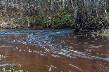 A small rocky river in spring taken in Latvia with long exposure