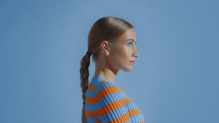 profile portrait of a young model in blue space studio wear colorful makeup