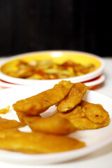 South Indian Potato Snack, Vazhakkai Bajji served on black background