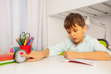 Little boy point to timer during development therapy lesson on background