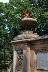 Old Stone Flower Pot with Colorful Flowers at Central Park in New York City during Summer