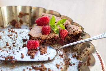 a piece of homemade tasty brownie with organic raspberries and mint - summer time