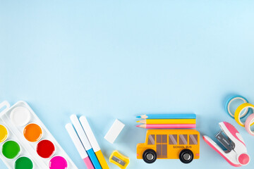 Various school office and painting supplies on blue background. Back to school concept. Top view....