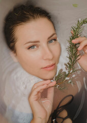 Beautiful young woman with clean fresh skin in a bathroom close-up.Cosmetology, beauty and spa.