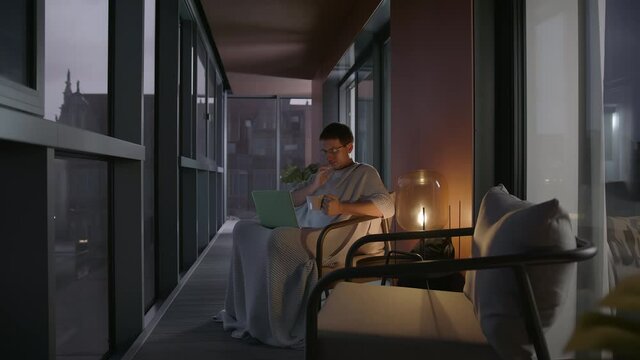 Slow-mo: Ill Handsome Caucasian Man Videoconferencing with Doctor In A Modern Apartment Balcony Using His Laptop