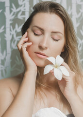 Close-up beautiful young woman with clean fresh skin with closed eyes.Cosmetology, beauty and spa.