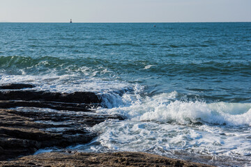 Aerial top view of sea waves hitting rocks on the beach