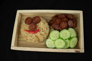 fried rice with fried chinese sausage and  fresh vegetables on wooden