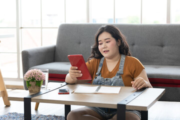 Chubby woman using a tablet computer for work and study