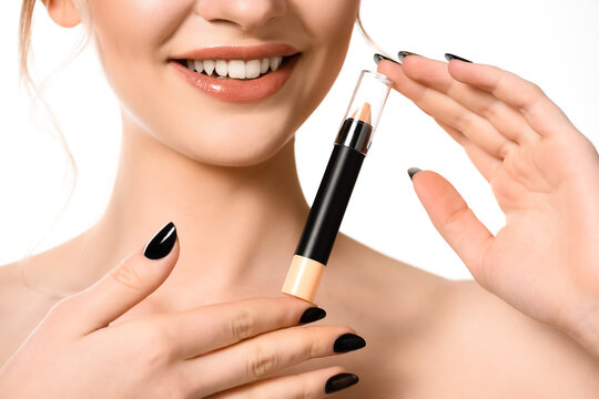 cropped view of smiling naked beautiful woman holding stick concealer isolated on white