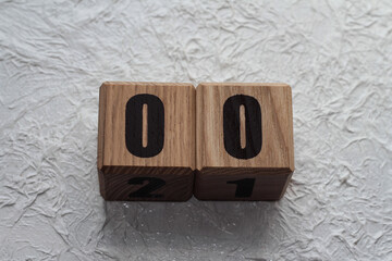 Wooden cubes with numbers on a white crumpled background. 00