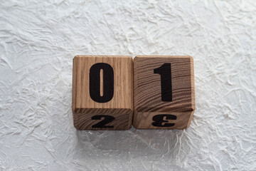 Wooden cubes with numbers on a white crumpled background. 01