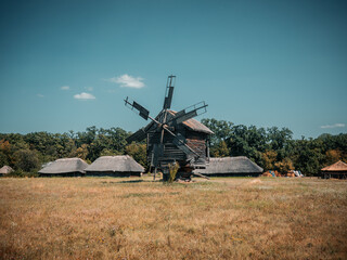 Fototapeta premium The traditional ukrainian wooden wind mill in the Pirogovo historical museum, Kiev, Ukraine