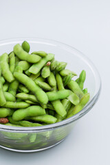 A traditional Chinese delicacy in solid color, boiled soybeans in brine. Chinese traditional food boiled soybean.