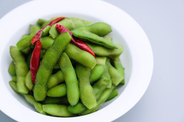 A traditional Chinese delicacy in solid color, boiled soybeans in brine. Chinese traditional food boiled soybean.